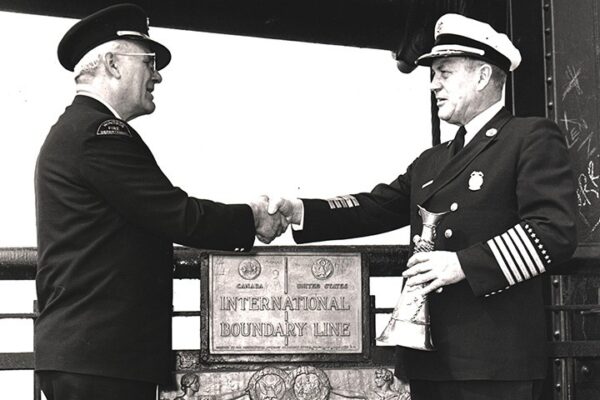 Hands across the border: Windsor Fire Chief Harold Coxon, left, thanks Detroit Chief Charles Quinlan
