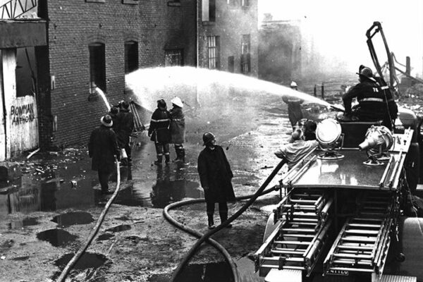 Ladder 2's deck nozzle knocks down fire at rear of the building