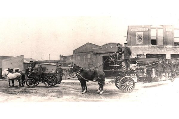 Pitt St. E. Central Fire Hall with horse-drawn hose wagon and aerial ladder truck, 1912
